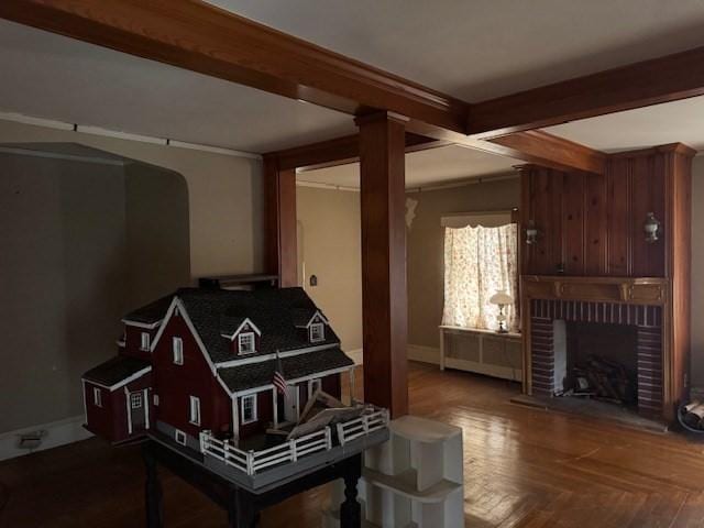 1002 Charles St, North Providence, RI 02904 - living area with beamed ceiling, a fireplace, and radiator