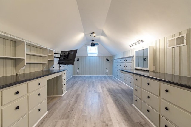 interior space with lofted ceiling, light wood-style flooring, white cabinetry, open shelves, and dark countertops