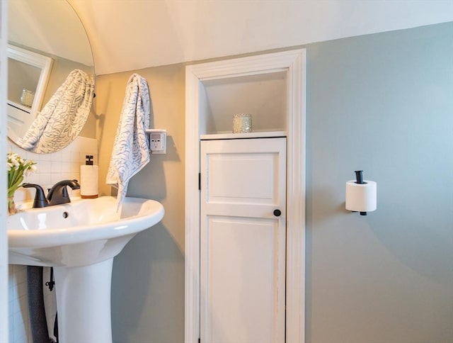 bathroom with a sink and backsplash