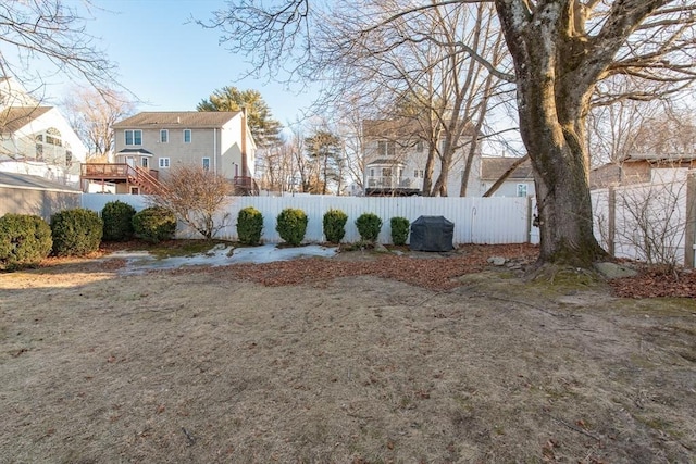 view of yard featuring fence private yard and stairway