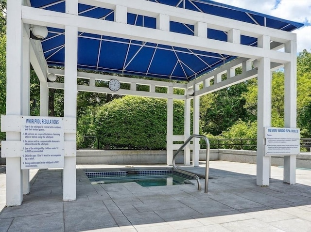 view of pool featuring a gazebo and a hot tub