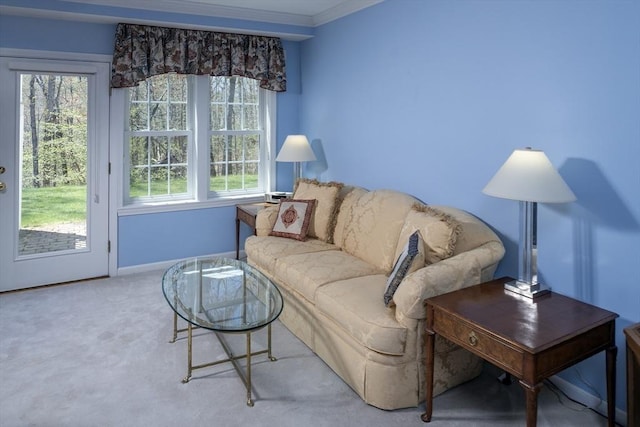 living room with a healthy amount of sunlight, carpet floors, baseboards, and ornamental molding