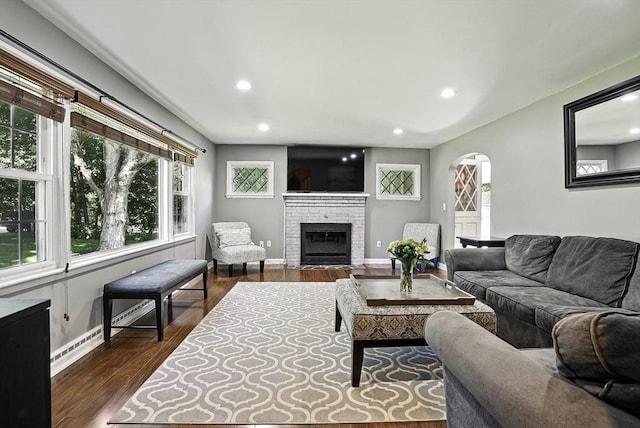 1112 Highland St, Holliston, MA 01746 - living area featuring baseboards, plenty of natural light, a fireplace, dark wood-style flooring, and recessed lighting