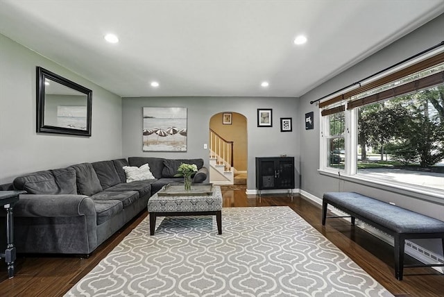 1112 Highland St, Holliston, MA 01746 - living area featuring arched walkways, recessed lighting, dark wood-style floors, stairway, and baseboards