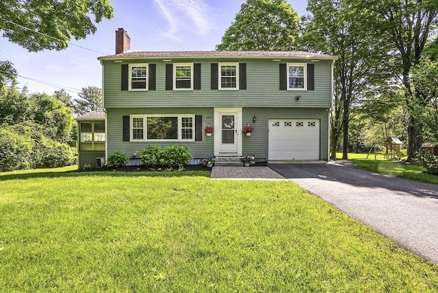 1112 Highland St, Holliston, MA 01746 - colonial-style house featuring a chimney, a garage, asphalt driveway, and a front lawn