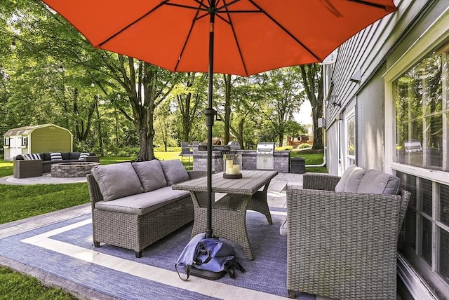 1112 Highland St, Holliston, MA 01746 - view of patio / terrace with an outdoor living space with a fire pit, an outdoor structure, and view of wooded area
