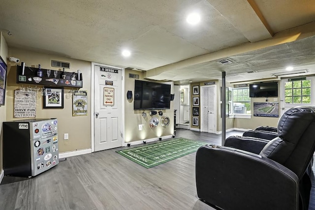 1112 Highland St, Holliston, MA 01746 - living room with wood finished floors, baseboards, and recessed lighting