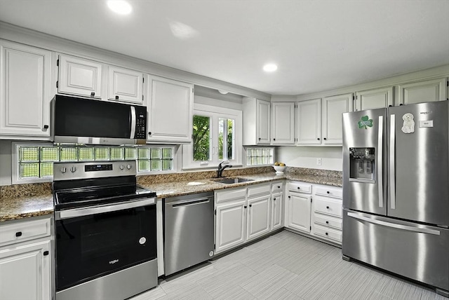 1112 Highland St, Holliston, MA 01746 - kitchen featuring stainless steel appliances, a sink, plenty of natural light, white cabinetry, and recessed lighting