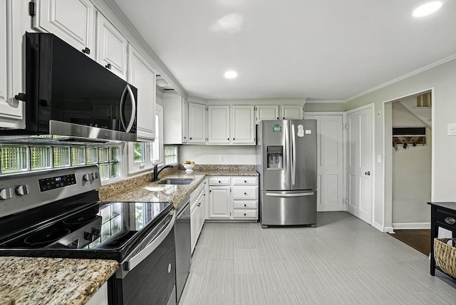 1112 Highland St, Holliston, MA 01746 - kitchen featuring stainless steel appliances, a sink, white cabinets, light stone countertops, and recessed lighting