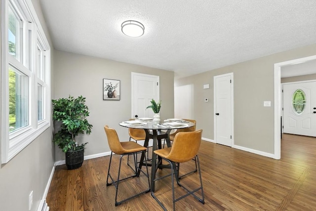 908 Tinkham Rd, Wilbraham, MA 01095 - dining space featuring a textured ceiling, wood finished floors, and healthy amount of natural light