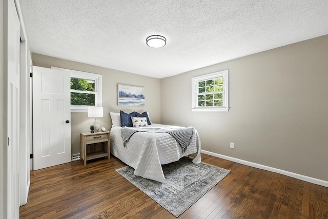 908 Tinkham Rd, Wilbraham, MA 01095 - bedroom with dark wood-style flooring and a textured ceiling
