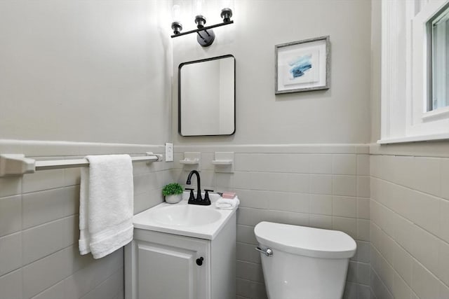 908 Tinkham Rd, Wilbraham, MA 01095 - half bathroom featuring vanity, tile walls, and a wainscoted wall