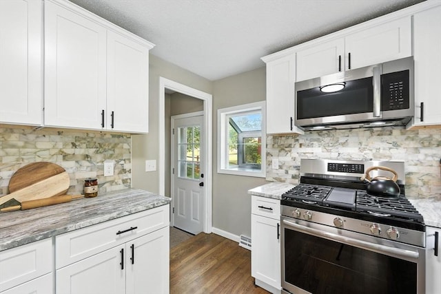 908 Tinkham Rd, Wilbraham, MA 01095 - kitchen with appliances with stainless steel finishes, dark wood-style floors, white cabinets, tasteful backsplash, and light stone counters