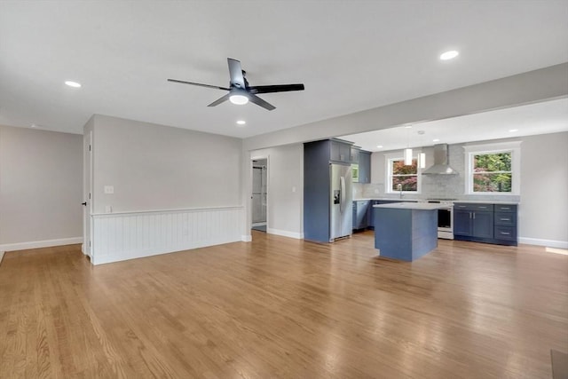 93 Pittroff Ave, South Hadley, MA 01075 - unfurnished living room with light wood-style flooring, a ceiling fan, recessed lighting, and a wainscoted wall