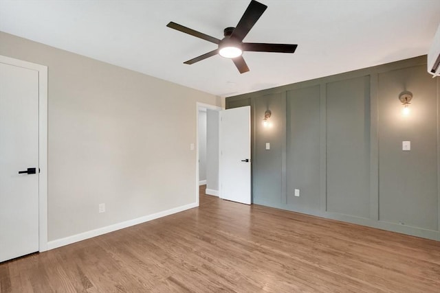 93 Pittroff Ave, South Hadley, MA 01075 - unfurnished bedroom with a decorative wall, light wood-type flooring, and ceiling fan