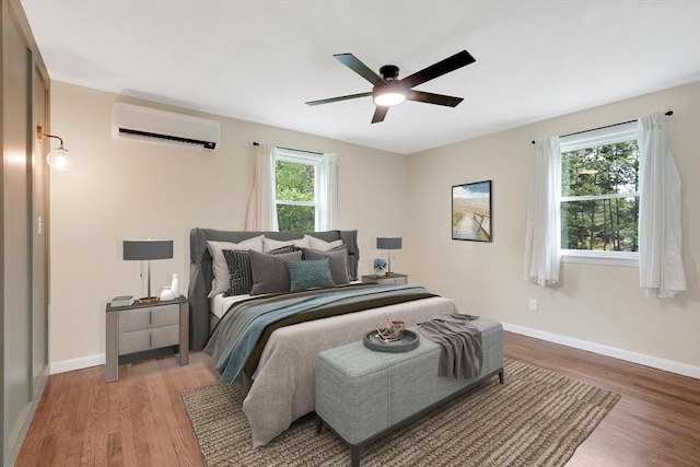 93 Pittroff Ave, South Hadley, MA 01075 - bedroom with a wall mounted air conditioner, light wood-style flooring, and a ceiling fan