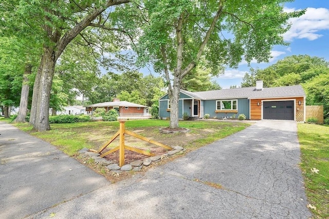 93 Pittroff Ave, South Hadley, MA 01075 - single story home featuring an attached garage, a chimney, driveway, and a front yard