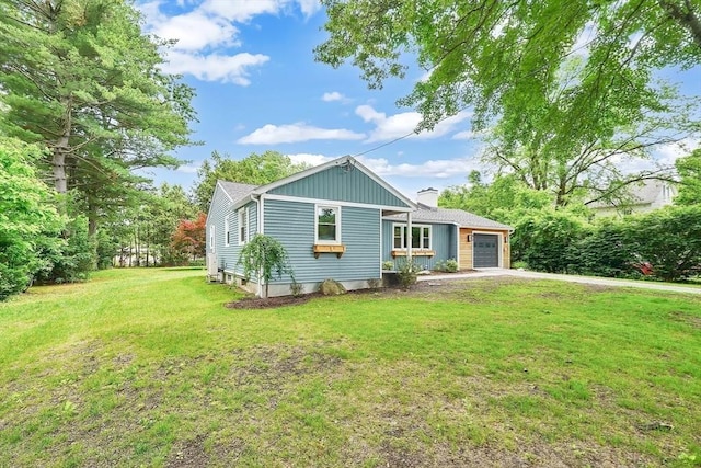 93 Pittroff Ave, South Hadley, MA 01075 - view of front facade with a chimney, a garage, driveway, and a front lawn