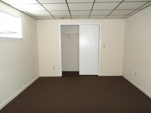 57 Bloomingdale St, Chelsea, MA 02150 - unfurnished bedroom with dark carpet, a paneled ceiling, and baseboards