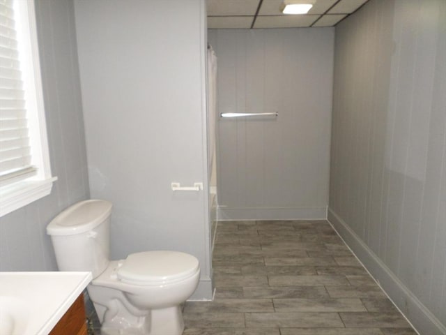 57 Bloomingdale St, Chelsea, MA 02150 - bathroom featuring vanity, wood tiled floor, a paneled ceiling, toilet, and shower / tub combo with curtain