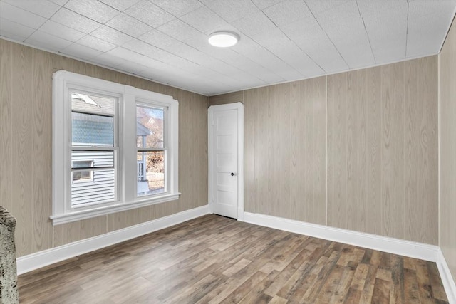 unfurnished room featuring wood finished floors and baseboards