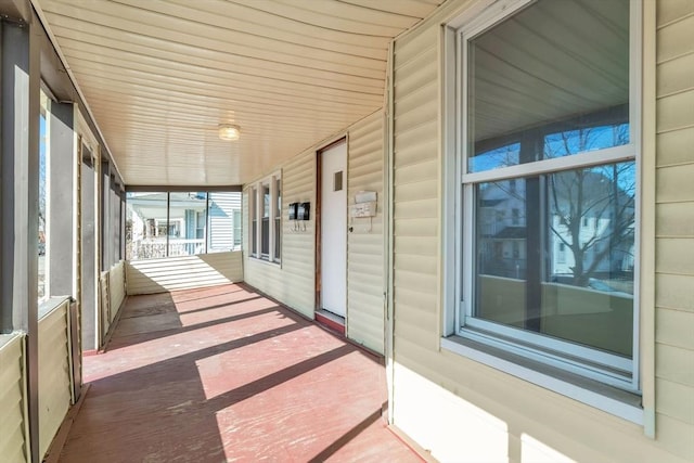 unfurnished sunroom with wooden ceiling