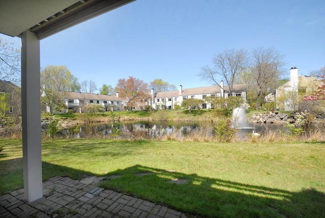 view of yard featuring a water view and a residential view
