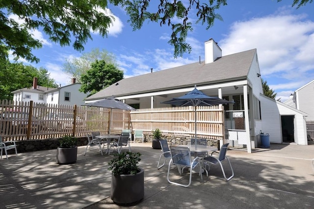 view of patio featuring fence and outdoor dining space