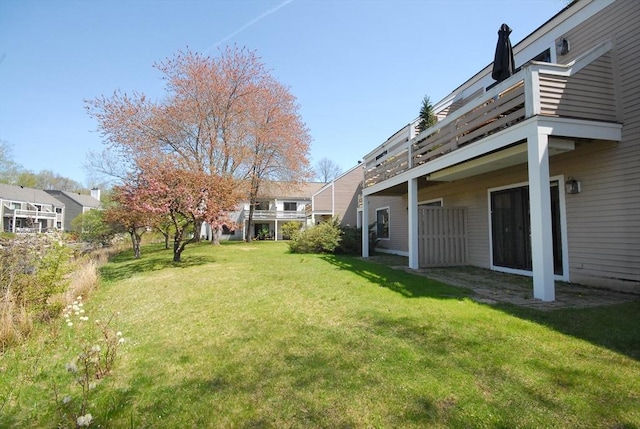 view of yard featuring a balcony