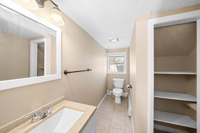 bathroom featuring visible vents, toilet, vanity, baseboards, and tile patterned floors