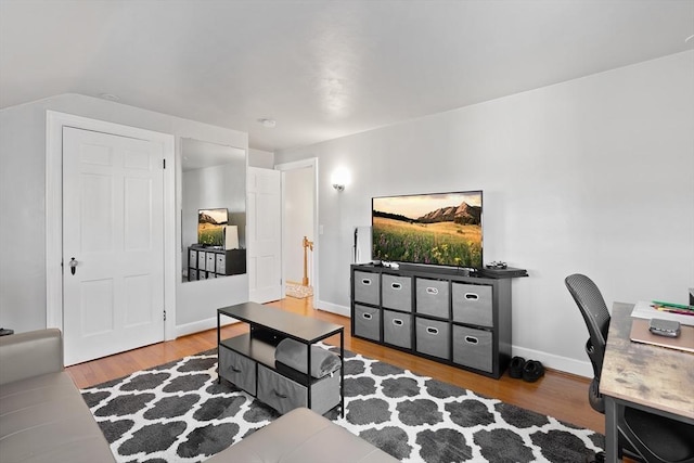 living room with baseboards and wood finished floors