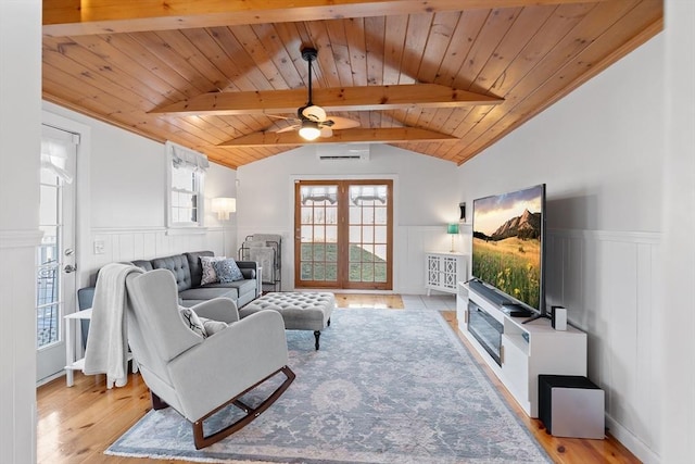 living room featuring light wood-style floors, wood ceiling, a wainscoted wall, and french doors