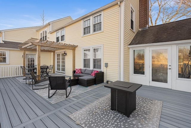 wooden terrace featuring an outdoor hangout area and a pergola