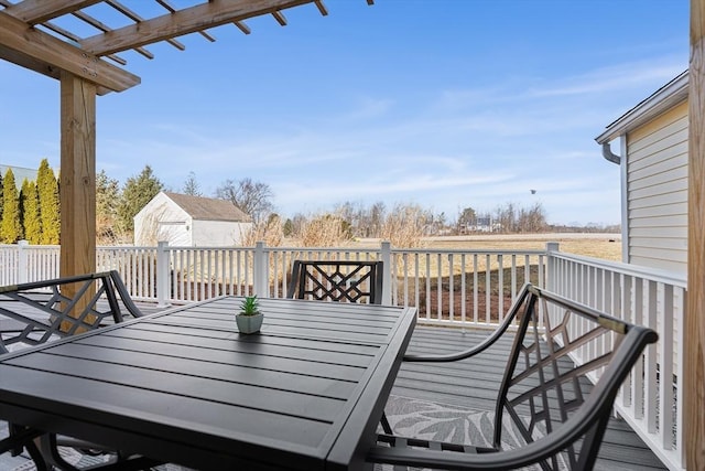 deck with an outdoor structure, outdoor dining space, a storage shed, and a pergola