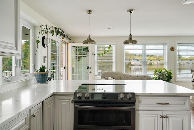2 Coles Grove Rd, Derry, NH 03038 - kitchen with electric range oven, french doors, light countertops, decorative light fixtures, and white cabinets
