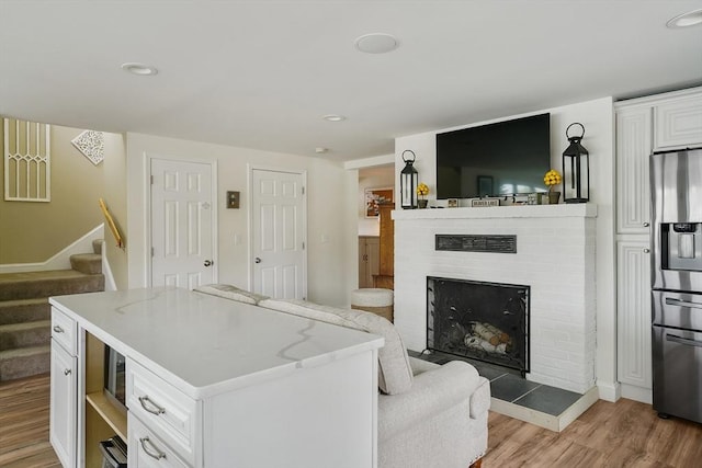 2 Coles Grove Rd, Derry, NH 03038 - living room featuring light wood finished floors, stairway, a fireplace, recessed lighting, and baseboards