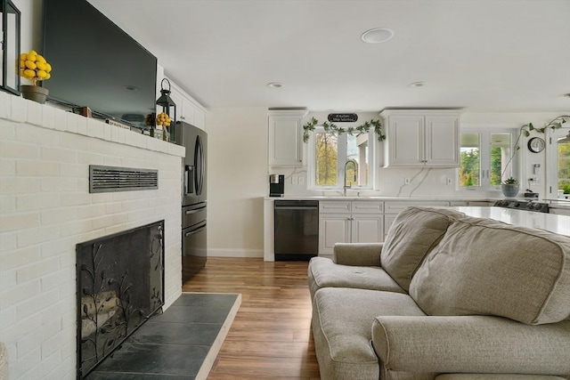 2 Coles Grove Rd, Derry, NH 03038 - living area with wood finished floors, a fireplace, baseboards, and recessed lighting