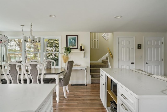 2 Coles Grove Rd, Derry, NH 03038 - dining space featuring a chandelier, stairway, dark wood finished floors, and recessed lighting