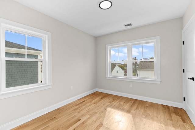 unfurnished room with light wood-type flooring