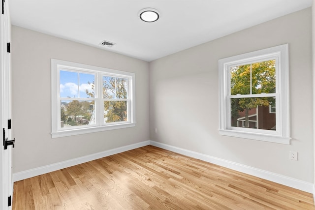 spare room with light hardwood / wood-style floors