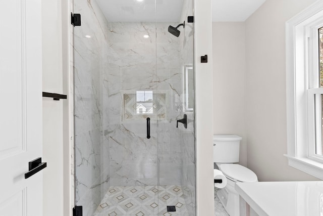 bathroom with toilet and an enclosed shower