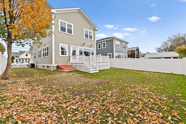 rear view of house featuring a yard