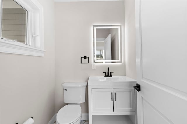 bathroom featuring toilet and vanity