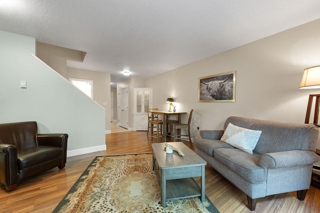 15 Roundhouse Rd Unit 15, Bourne, MA 02532 - living room with wood finished floors, baseboards, and stairs
