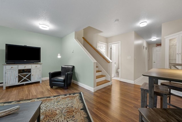 15 Roundhouse Rd Unit 15, Bourne, MA 02532 - living room featuring a textured ceiling, stairway, wood finished floors, and baseboards