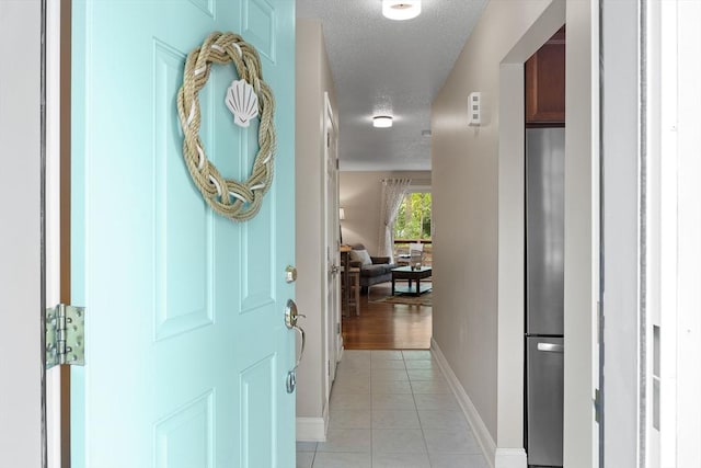 15 Roundhouse Rd Unit 15, Bourne, MA 02532 - foyer entrance with a textured ceiling, baseboards, and light tile patterned flooring