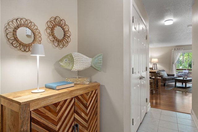 15 Roundhouse Rd Unit 15, Bourne, MA 02532 - hall with a textured ceiling, light tile patterned floors, and baseboards