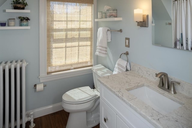 full bath with vanity, radiator heating unit, a healthy amount of sunlight, and toilet