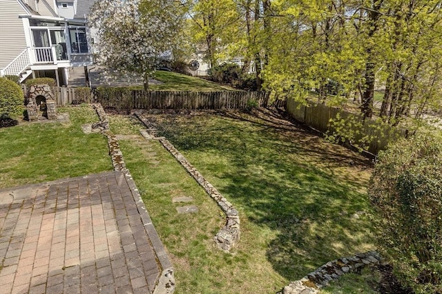 view of yard with a fenced backyard and a sunroom