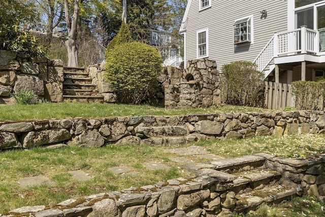 view of yard with fence and stairs